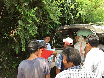 Kaung Nyunt and Kyaw Zin Win help volunteers load a truck with rice and other supplies.